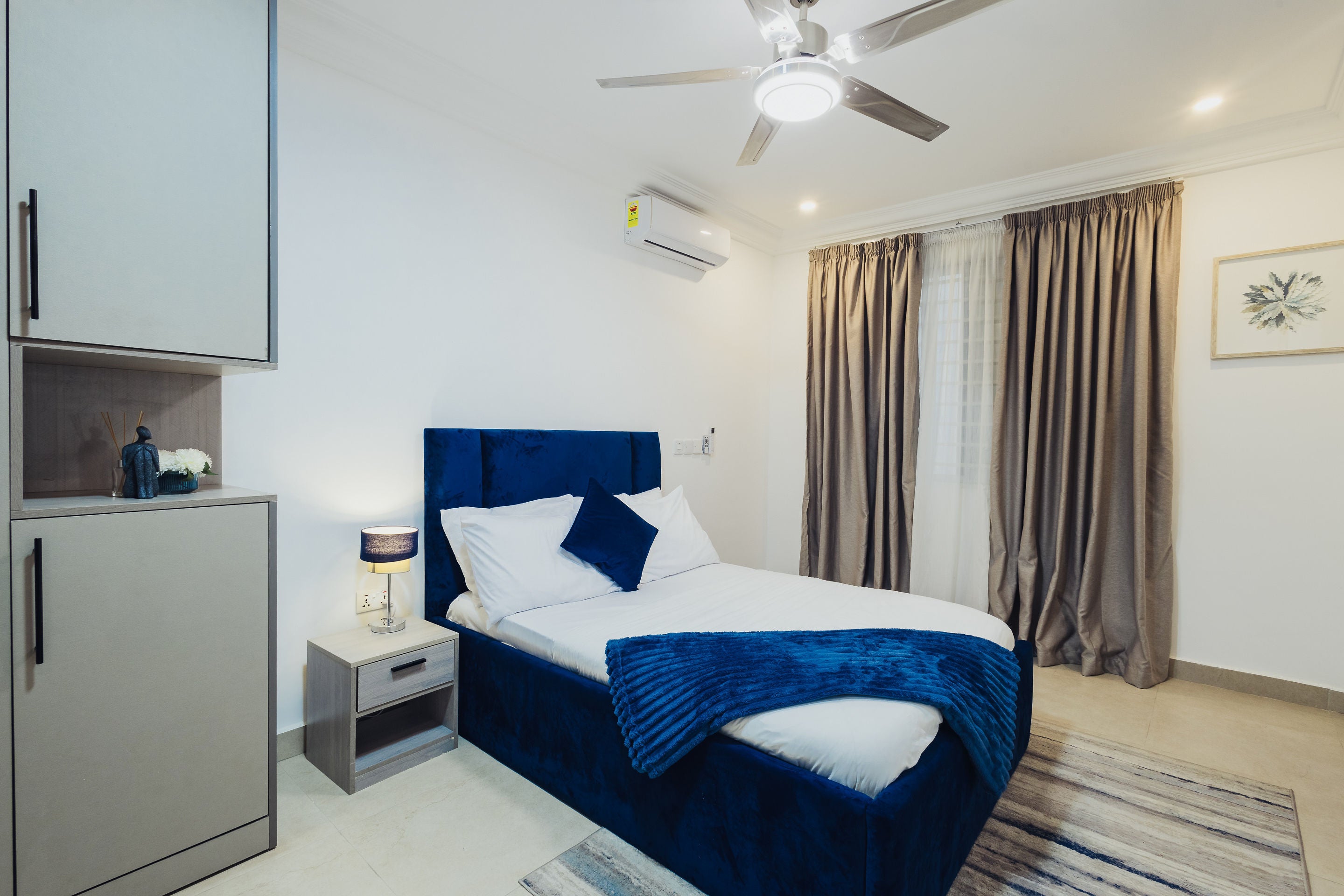 Bedroom with navy velvet headboard