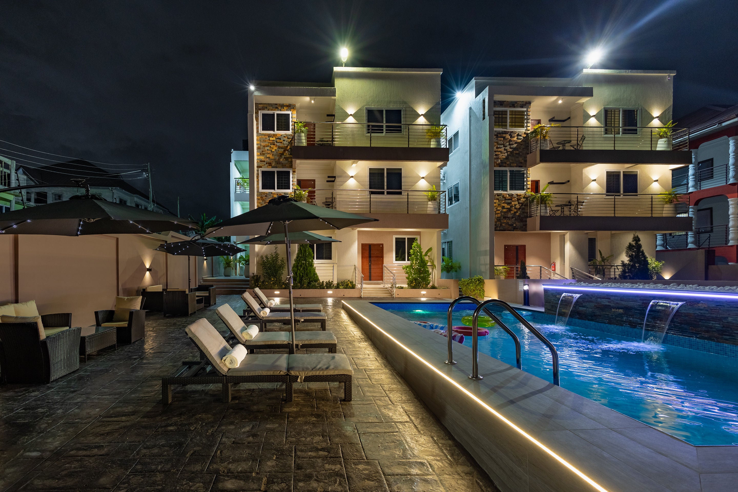 Swimming pool glowing blue at night