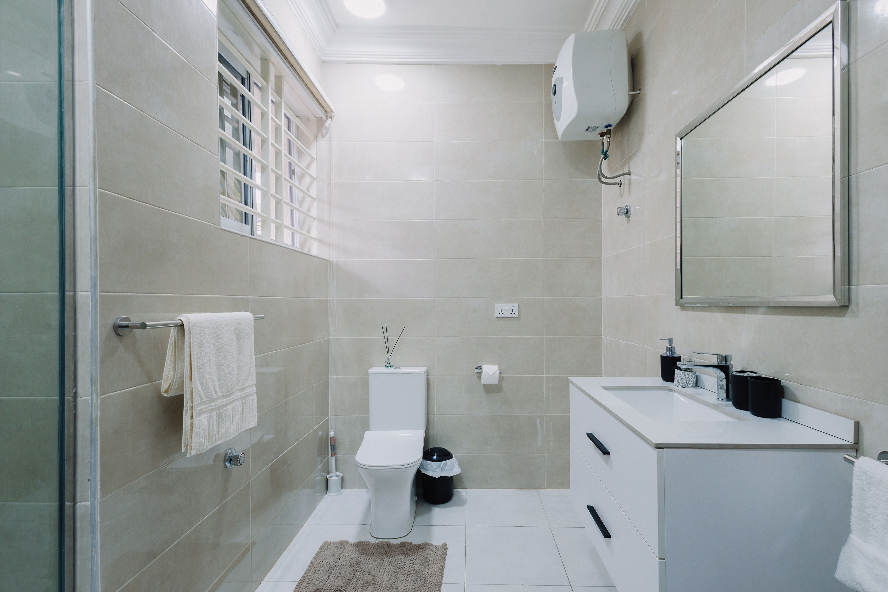 Bathroom with large mirror and rain shower